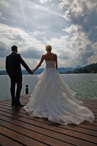 Newlywed couple by lake