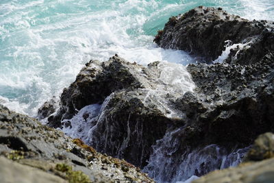 Scenic view of rocks at sea shore