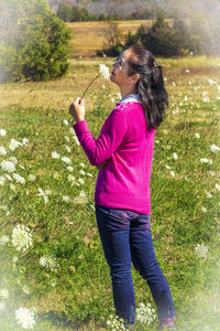 Side view of woman standing on field