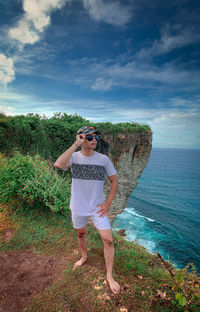 A man  standing by sea against sky