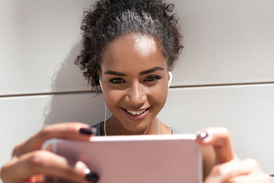Close-up of young woman using mobile phone