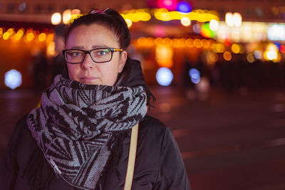 Portrait of woman wearing scarf at night