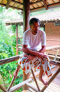 Portrait of young man sitting outdoors