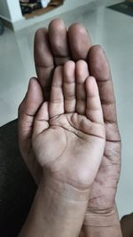 Close-up of hands holding baby