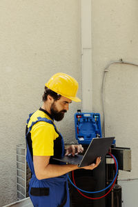 Rear view of man working at construction site