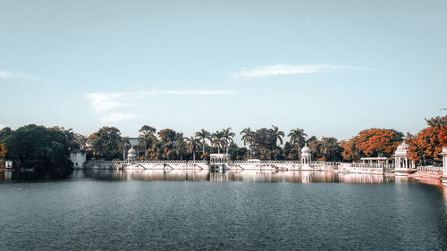 Scenic view of lake by trees against sky