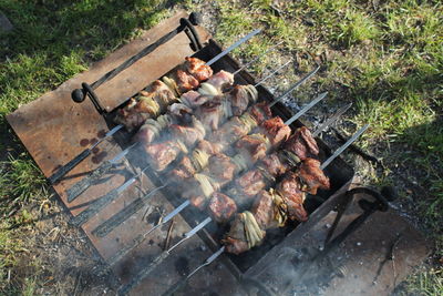 High angle view of meat on barbecue grill