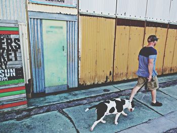 Full length of woman standing on railing