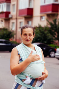 Portrait of mother with baby on road