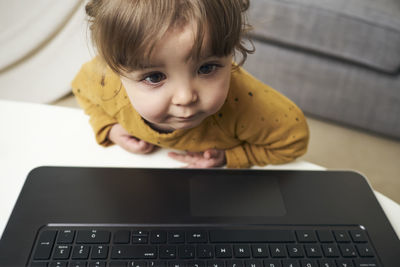 Adorable baby with a laptop