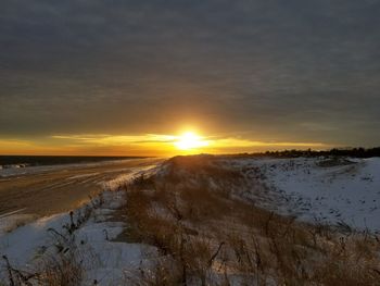 Scenic view of beach against sky during sunset