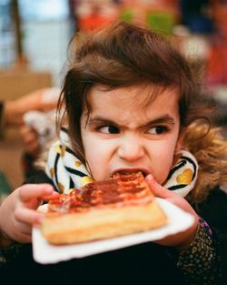 Close-up portrait of a woman eating food