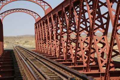 Railroad tracks in bridge against sky