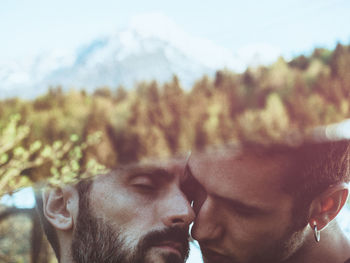 Reflection of romantic gay couple on mirror