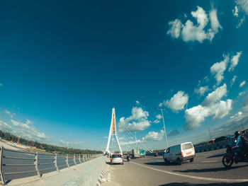 Cars on road against blue sky