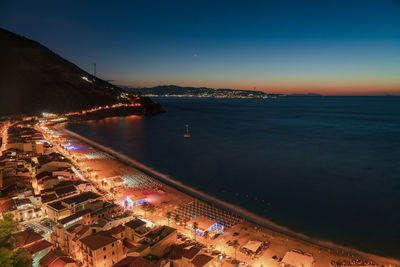 High angle view of city lit up at night