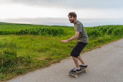 Side view of young man on road