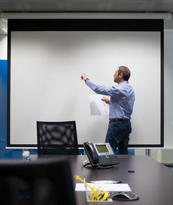 Full length of man working on laptop