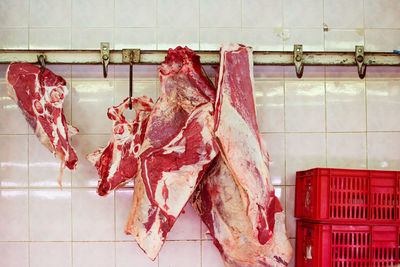 High angle view of meat hanging on wall at market for sale