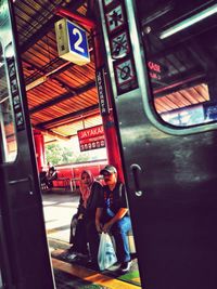 Portrait of people standing in train