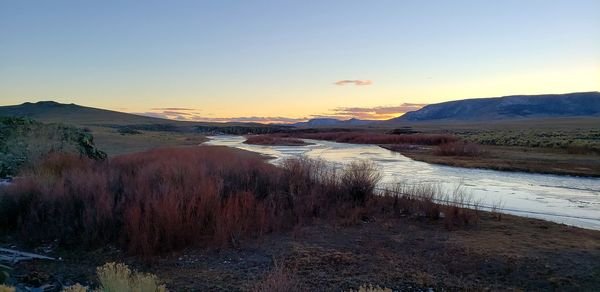 Scenic view of land against sky during sunset