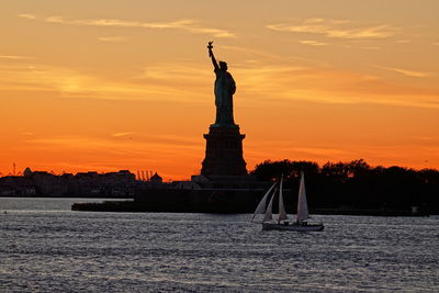 Statue of liberty against sky during sunset