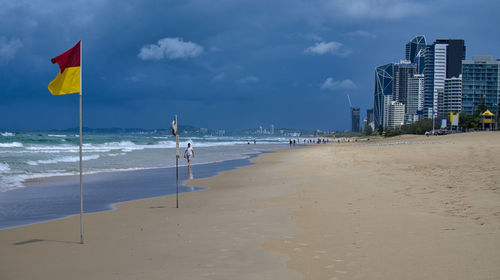 Scenic view of beach against sky in city