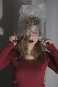 Portrait of lonely women wearing a plastic bag full of kisses 