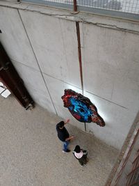 High angle view of people walking on tiled floor