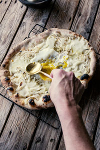 Cropped hand of person preparing food