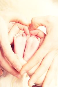 Close-up of mother holding baby hand