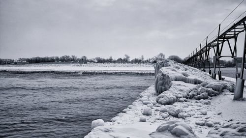 Bridge over sea against sky