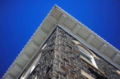 Low angle view of building against clear blue sky