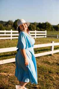 Portrait of smiling woman standing on field