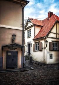 Buildings in town against sky