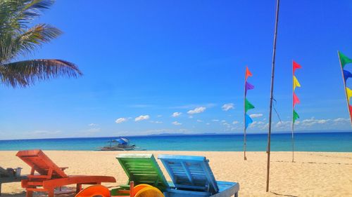 Scenic view of beach against blue sky