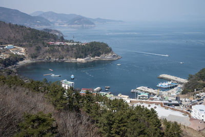 Scenic view of sea and mountains against sky