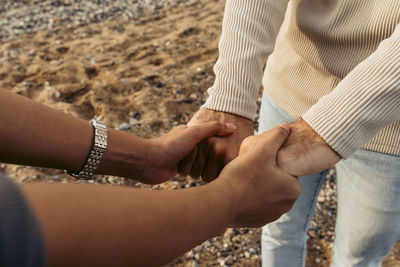 Young couple holding hands at beach