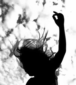 Low angle view of woman against sky