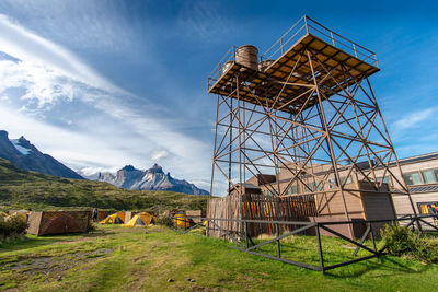 Traditional windmill on field against sky