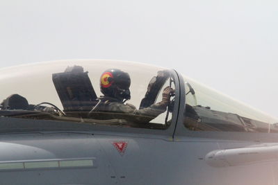 Man sitting on airplane against clear sky