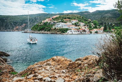 Scenic view of sea by buildings against sky