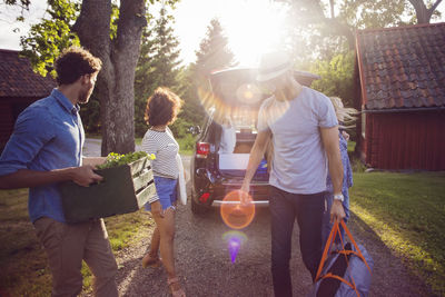 Rear view of people standing at yard