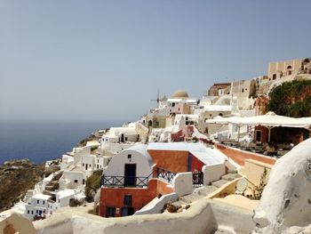 Townscape by sea against clear sky