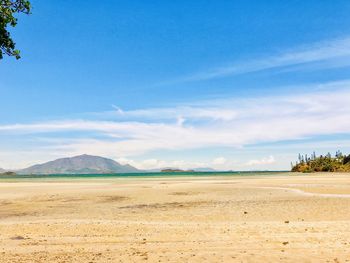 Scenic view of desert against blue sky