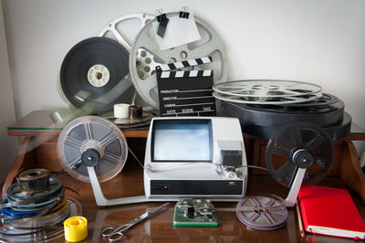 Film slate and reel spools with equipment on table