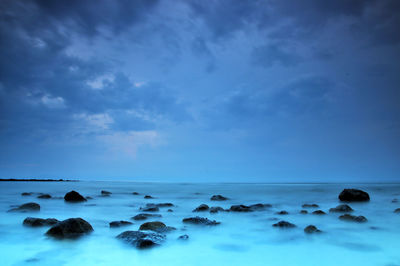 Scenic view of sea against blue sky