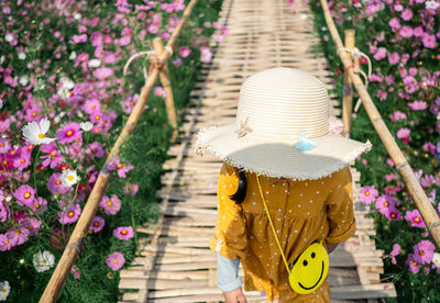 Midsection of woman with yellow flowers