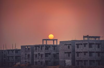 Buildings in city at sunset