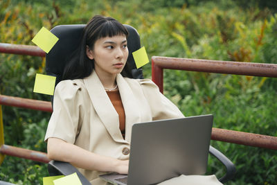 Young woman using mobile phone outdoors